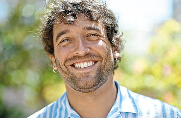 Young hispanic man smiling confident standing at park